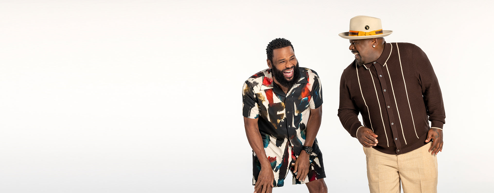 Anthony Anderson and Cedric the Entertainer smiling and laughing