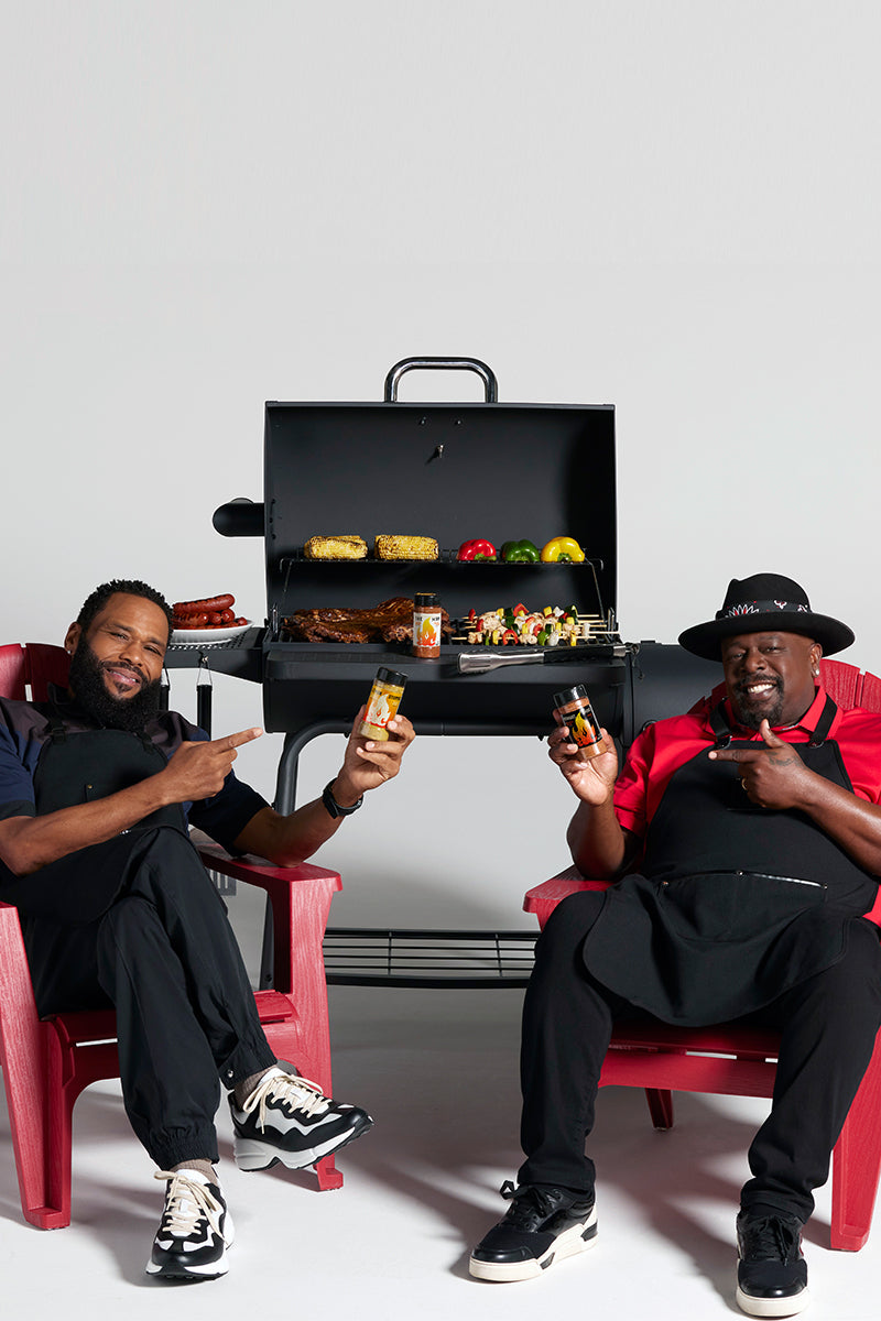 Anthony Anderson and Cedric the Entertainer promoting AC Barbeque rubs while sitting in front of grill